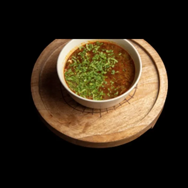 Bowl of Georgian kharcho beef soup with herbs